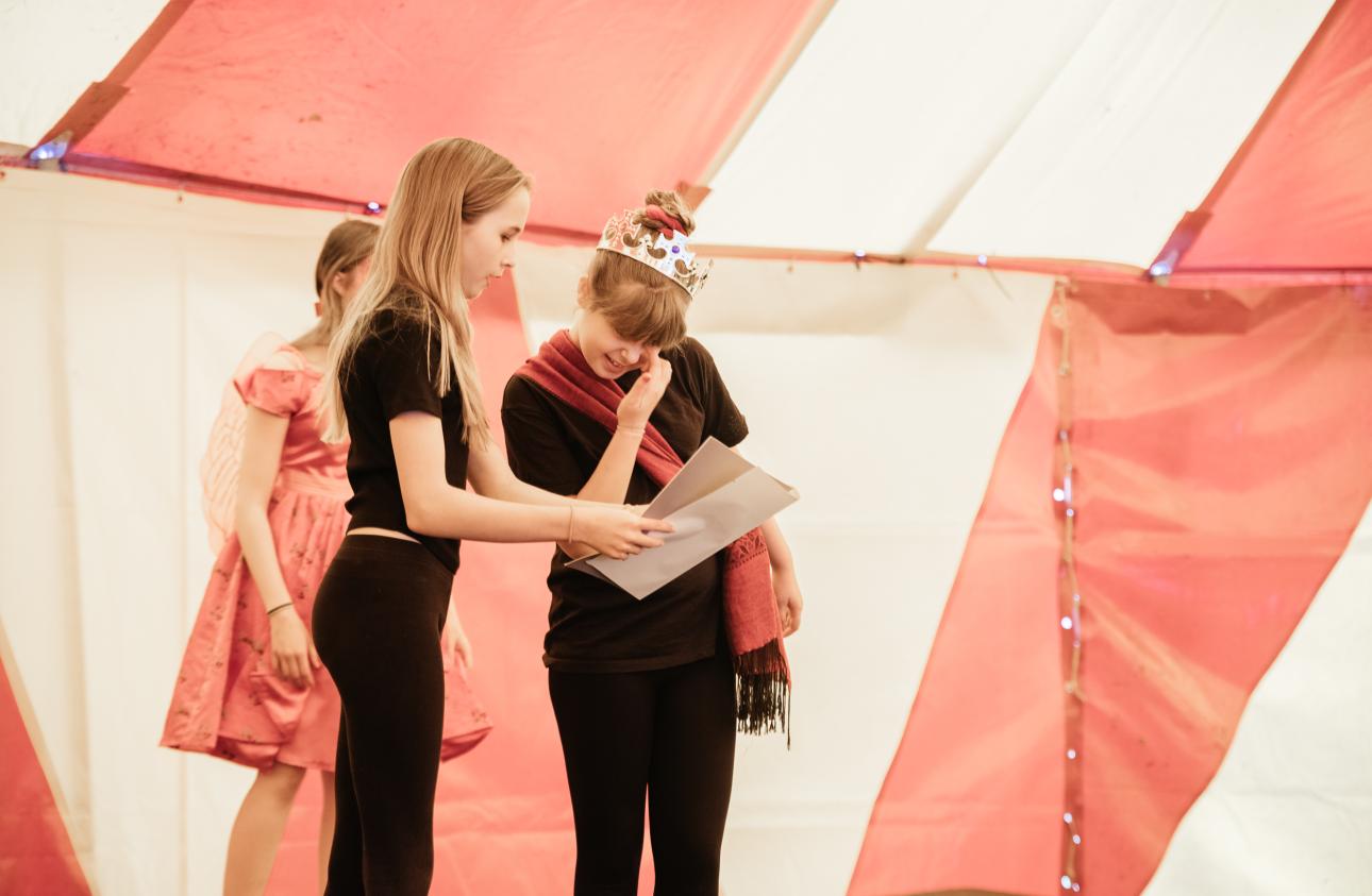 three young people tell stories on stage in a big top at tapton lock festival