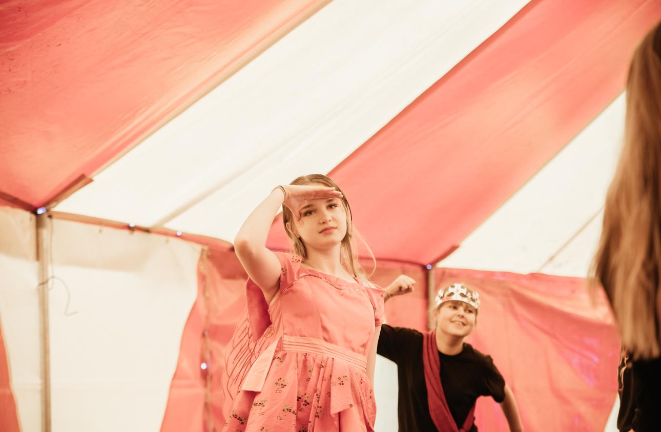 two young people tell stories on stage in a big top at tapton lock festival