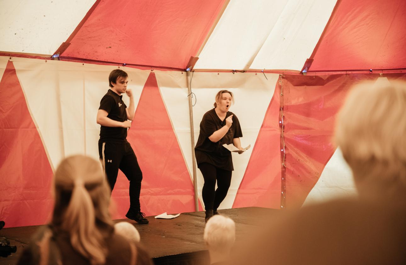 two young people tells stories on stage in the big top at tapton lock festival