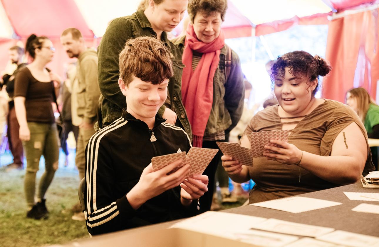 4 people working with the illustrated story cards in the big top at tapton lock festival