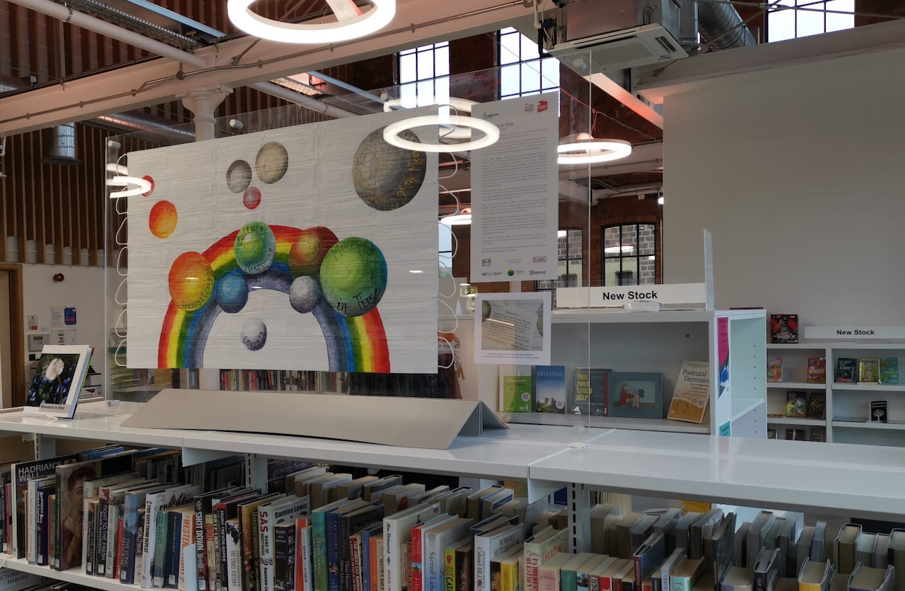 artwork on display in belper library on top of a bookcase