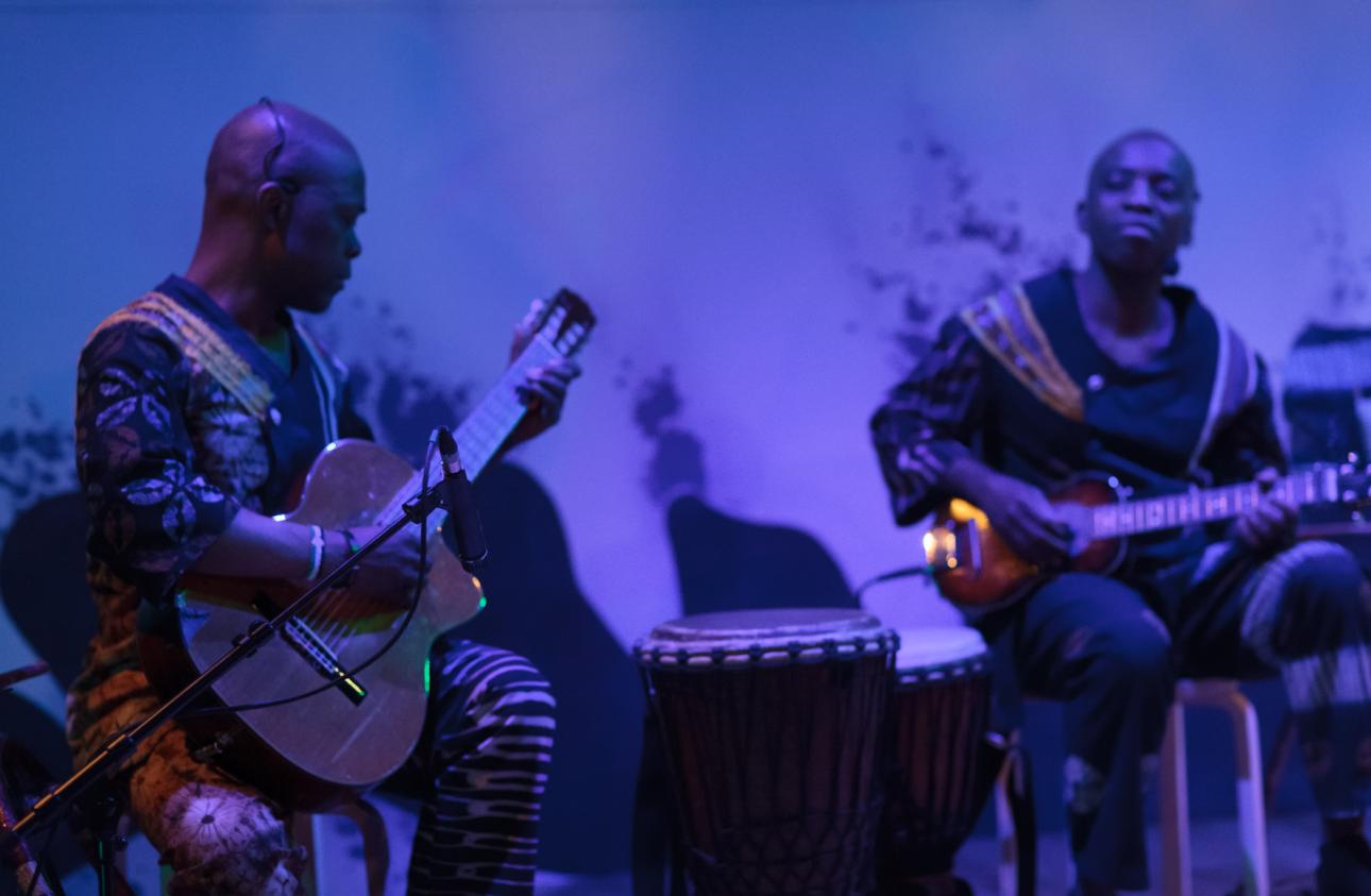 Raymond and Kouame Sereba playing guitars