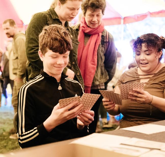 4 people working with illustrated story cards in the big top at tapton lock festival