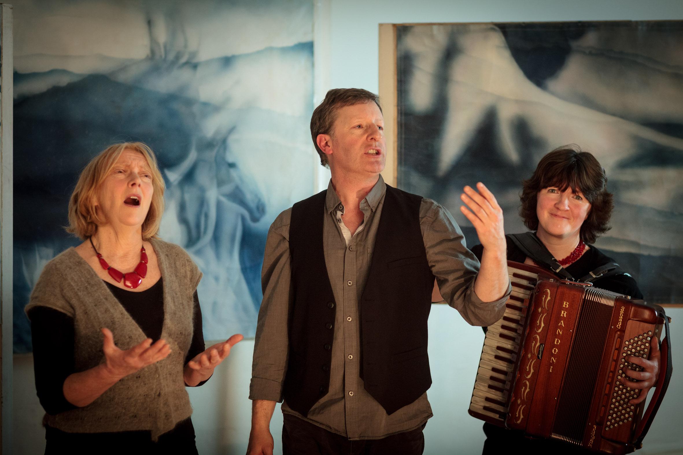 from left to right - Lynne Denman, Michael Harvey and Stacey Blythe in an ensemble shot in front of a large blue backdrop