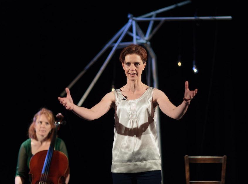 katy cawkwell stands in the foreground with arms outstretched. Sarah Llwellyn-Jones in the background with cello